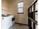 Functional laundry room with a washer, dryer, storage shelves, and a window, making chores a breeze at 5838 W Bayfield Dr, McCordsville, IN 46055