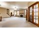 Spacious open-concept living room with a fireplace, ceiling fan, and views to the dining area at 5838 W Bayfield Dr, McCordsville, IN 46055