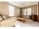 Bright and inviting living room with a comfortable sofa, a wooden coffee table, and a large window at 5838 W Bayfield Dr, McCordsville, IN 46055