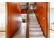 Bright foyer featuring a carpeted staircase, rich wood trim, and a glimpse into the living spaces at 5838 W Bayfield Dr, McCordsville, IN 46055