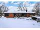 Brick ranch home with snow-covered lawn at 620 Mulberry St, Zionsville, IN 46077