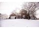 Two-story brick home with attached garage, snow-covered lawn, and large tree at 6663 Trailside Dr, Avon, IN 46123