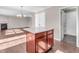 Kitchen island with a light countertop and wood cabinets open to the living room with fireplace at 6663 Trailside Dr, Avon, IN 46123