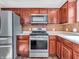 Kitchen area featuring stainless steel appliances and wood cabinets with a tiled backsplash at 6663 Trailside Dr, Avon, IN 46123