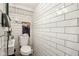 Small bathroom with white subway tiles and essential fixtures at 6711 E 10Th St, Indianapolis, IN 46219