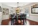 Charming dining room with dark wood table and hardwood floors at 6711 E 10Th St, Indianapolis, IN 46219