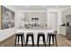 Kitchen island with seating for four, quartz countertop, and stainless steel appliances at 682 Penrose Pl, Danville, IN 46122