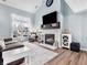 Bright living room featuring a fireplace, hardwood floors, and large windows at 793 Hollowood Ln, Avon, IN 46123