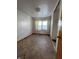 A small bedroom with damaged hardwood floors needing renovation at 818 W 12Th St, Indianapolis, IN 46202