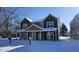 Two-story house with green and tan siding, snow covered yard at 841 Udell St, Indianapolis, IN 46208