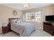 Well-lit bedroom featuring a comfortable bed and wood dresser at 8782 Bay Pointe Cir, Indianapolis, IN 46236