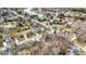 An aerial shot of a residential neighborhood with mature trees and landscaping, near a small lake at 9275 Eastwind Dr, Indianapolis, IN 46256