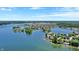 An aerial view of lakeside homes with private docks on a scenic lake under a clear blue sky at 9275 Eastwind Dr, Indianapolis, IN 46256