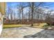 Beautiful backyard with a stone paver patio and grassy area with mature trees at 9275 Eastwind Dr, Indianapolis, IN 46256