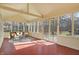 Sunroom with wood ceiling and wicker furniture overlooking the patio and well-manicured backyard at 9275 Eastwind Dr, Indianapolis, IN 46256