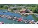 A waterfront restaurant features outdoor seating next to a marina full of docked boats on a sunny day at 9275 Eastwind Dr, Indianapolis, IN 46256