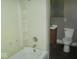 Functional bathroom features a toilet, sink, and shower-tub combo at 1138 W 33Rd St, Indianapolis, IN 46208