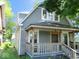 Stylish home showcasing a covered front porch, updated siding, and a welcoming entrance at 1138 W 33Rd St, Indianapolis, IN 46208