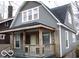 Gray house with wooden porch and snowy yard at 1138 W 33Rd St, Indianapolis, IN 46208