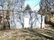 A detached garage with light gray siding and a single entry door at 1138 W 33Rd St, Indianapolis, IN 46208