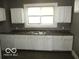 Simple kitchen with white cabinets and dark countertop at 1138 W 33Rd St, Indianapolis, IN 46208