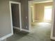 Spacious living area with neutral colors, and an open doorway creating a seamless transition to another room at 1138 W 33Rd St, Indianapolis, IN 46208