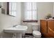 Clean bathroom with a toilet, sink, and wooden vanity at 125 W 11Th St, Anderson, IN 46016