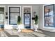 Inviting front porch with a blue door and potted plants at 1471 N Delaware St, Indianapolis, IN 46202