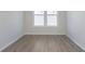 Bedroom featuring wood-look flooring, a large window, and neutral paint at 14878 Desert Orchid Dr, Westfield, IN 46074