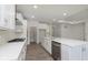 Modern kitchen featuring white cabinets, stainless steel appliances, hardwood flooring, and a center island at 14878 Desert Orchid Dr, Westfield, IN 46074