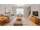 Living room featuring hardwood floors, neutral decor, and comfortable seating at 15236 Countfleet Ct, Carmel, IN 46032