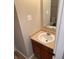 Clean bathroom with a single sink vanity and wood cabinets at 1608 Wagner Dr, Shelbyville, IN 46176