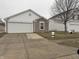 Ranch style home with 2-car garage and landscaped yard at 1608 Wagner Dr, Shelbyville, IN 46176