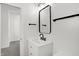 Clean bathroom with white vanity, black matte fixtures, and a large mirror at 1631 Brier Pl, Indianapolis, IN 46203