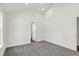 Simple bedroom with gray carpet and a view of the bathroom at 1631 Brier Pl, Indianapolis, IN 46203