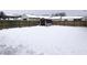 Snowy backyard with wooden fence and storage shed at 1685 Juniper Dr, Columbus, IN 47201