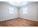 Spacious bedroom with hardwood floors and two windows at 1707 E 45Th St, Anderson, IN 46013