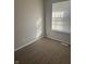 Well-lit carpeted bedroom with window and neutral walls at 2450 Morning Star Dr, Indianapolis, IN 46229