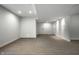 Finished basement with gray vinyl flooring and recessed lighting at 2541 Royal Blvd, Carmel, IN 46032