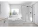 Bright bathroom featuring soaking tub and walk-in shower at 2541 Royal Blvd, Carmel, IN 46032