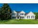 Two-story house with gray brick, black shutters, and a manicured lawn at 2541 Royal Blvd, Carmel, IN 46032