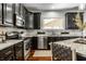 Updated kitchen featuring dark wood cabinets, granite countertops, and stainless steel appliances at 2541 Royal Blvd, Carmel, IN 46032