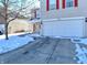 Two-story townhome with attached garage, snow on ground at 2925 Everbloom Pl, Indianapolis, IN 46217