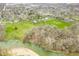 Scenic aerial view of a residential area with a river, lush greenery, and mature trees at 2940 Washington St, Columbus, IN 47201
