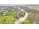 Scenic aerial view of winding river, lush green spaces, and nearby neighborhood offering a serene and picturesque setting at 2940 Washington St, Columbus, IN 47201