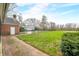 Spacious backyard with brick home, shed, black fence and mature trees at 2940 Washington St, Columbus, IN 47201