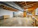 Unfinished basement with high ceilings, concrete floors, and plenty of space at 2940 Washington St, Columbus, IN 47201