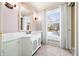 Bathroom with updated vanity, marble countertop and large window at 2940 Washington St, Columbus, IN 47201