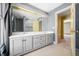 Double vanity bathroom with a large mirror and access to another room at 2940 Washington St, Columbus, IN 47201