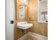 Small bathroom with a pedestal sink and wood-paneled walls at 2940 Washington St, Columbus, IN 47201